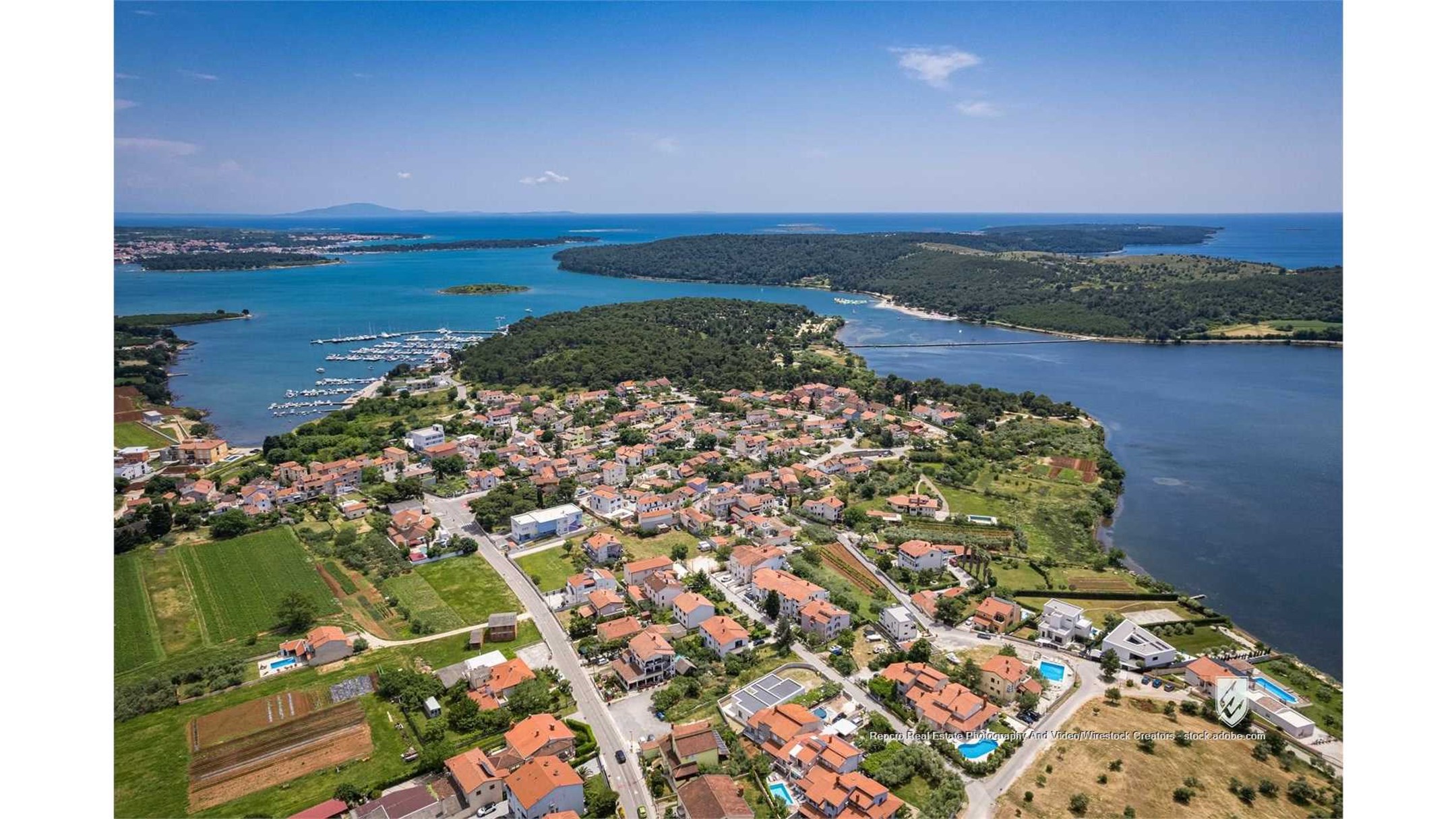 aerial pomer croatia coastal town oceanfront buildings harbor picturesque stunning view dramatic blue seaside village